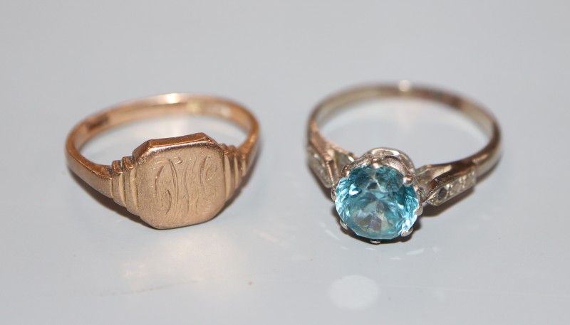 A 9ct gold signet ring(worn), 2.8 grams and a white metal and blue zircon(worn) dress ring, size N, gross 2.5 grams.